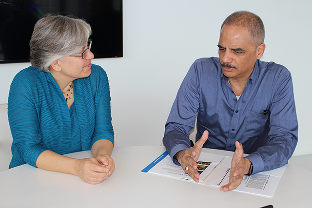 Judith Sandalow and Eric Holder sitting at a table