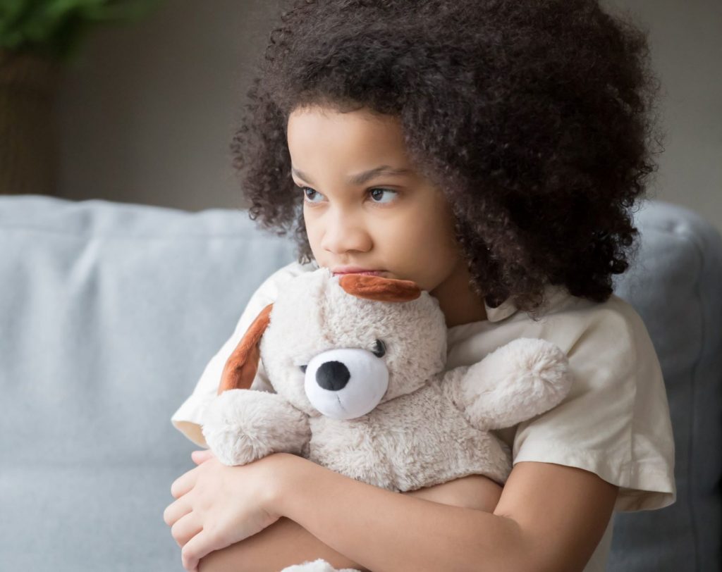 Child hugging a teddy bear