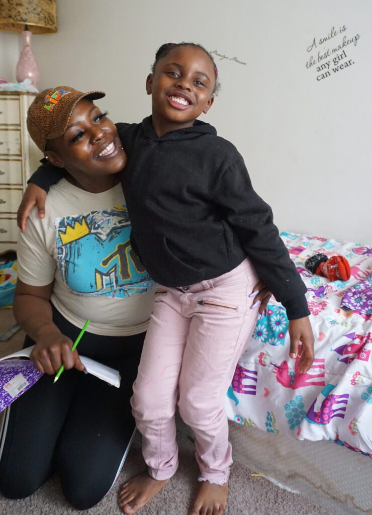 A mother and her daughter smiling