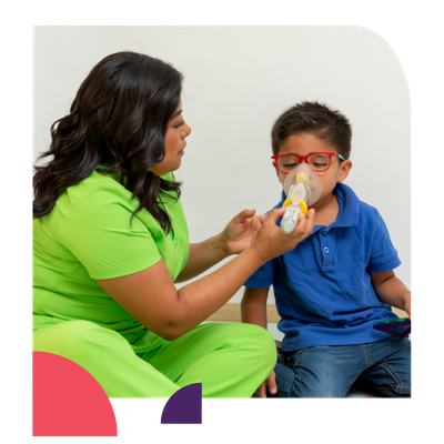A medical professional administers and inhaler to a child