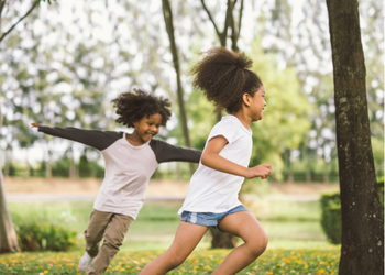 Two children playing in park.