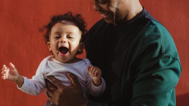 Parent holding young toddler