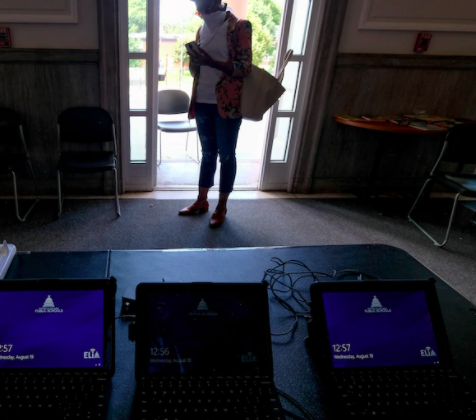 Photo of woman picking up devices.