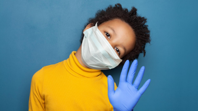 Photo of boy wearing mask and gloves