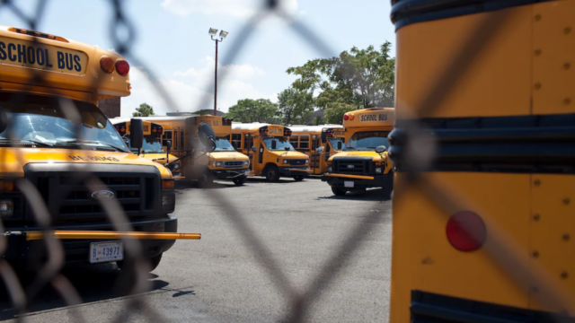 DC school buses behind a fence