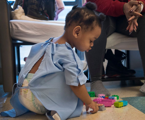 Photo of 2 year old Heavenz playing with toys.