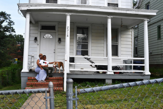 Photo of Chanelle Mattocks with her son Alonzo outside of their home.
