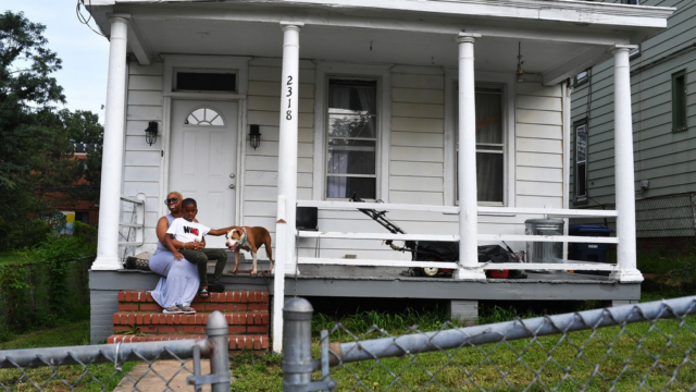 Photo of Chanelle Mattocks with her son Alonzo outside of their home