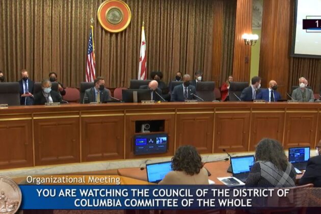 Screenshot of the DC Council in the John A. Wilson Building. Text banner says "Organizational Meeting: You are watching the Council of the District of Columbia Committee of the Whole.".