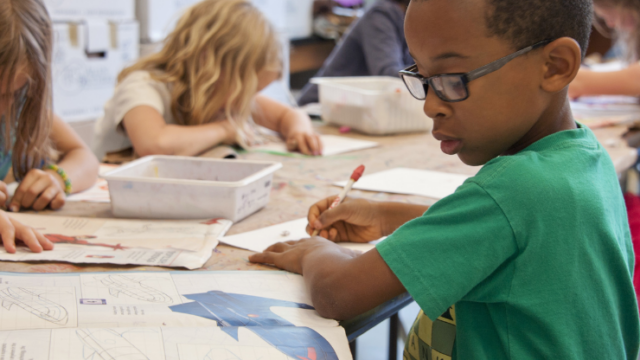 Boy in a classroom doing work