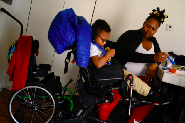 Photo of Ms. Chance with her son, Ayden, in a wheelchair.