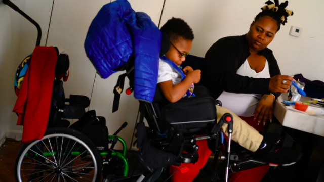 Photo of Ms. Chance with her son, Ayden, in a wheelchair